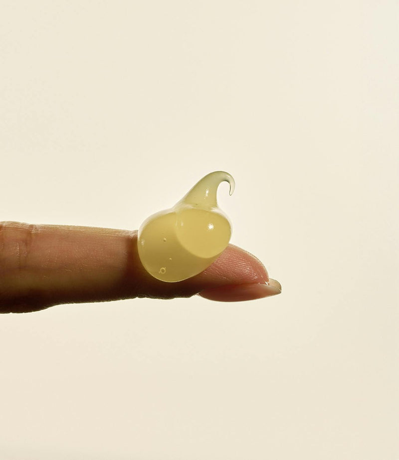 A sheer, clear swatch of invisible SPF 45 sunscreen on a fingertip